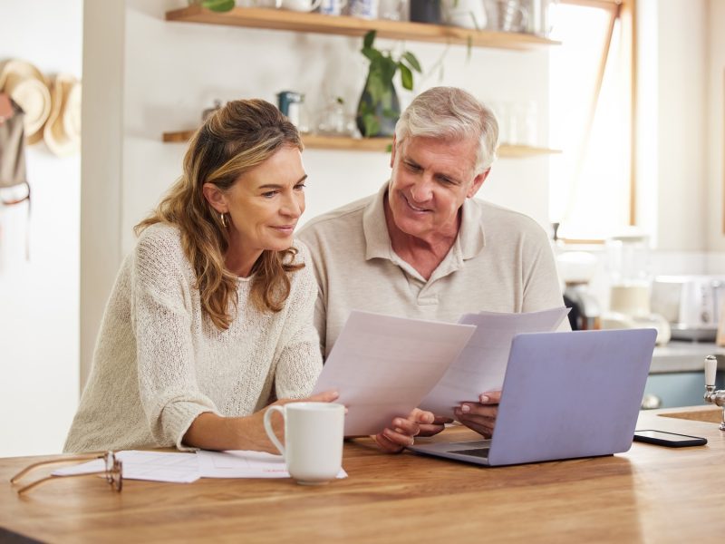 Retirement, finance and couple with budget on laptop satisfied with home expenses in New Zealand. H